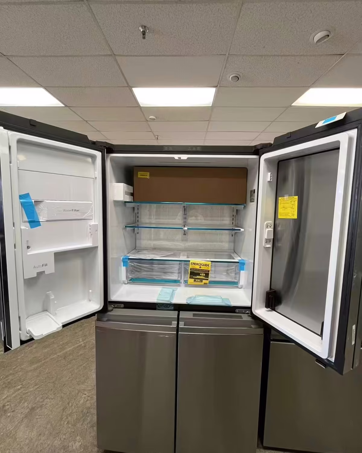 A black stainless refrigerator with its doors open