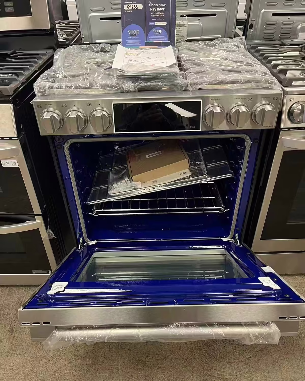 A gas range with a Snap Finance lease-to-own sign on top