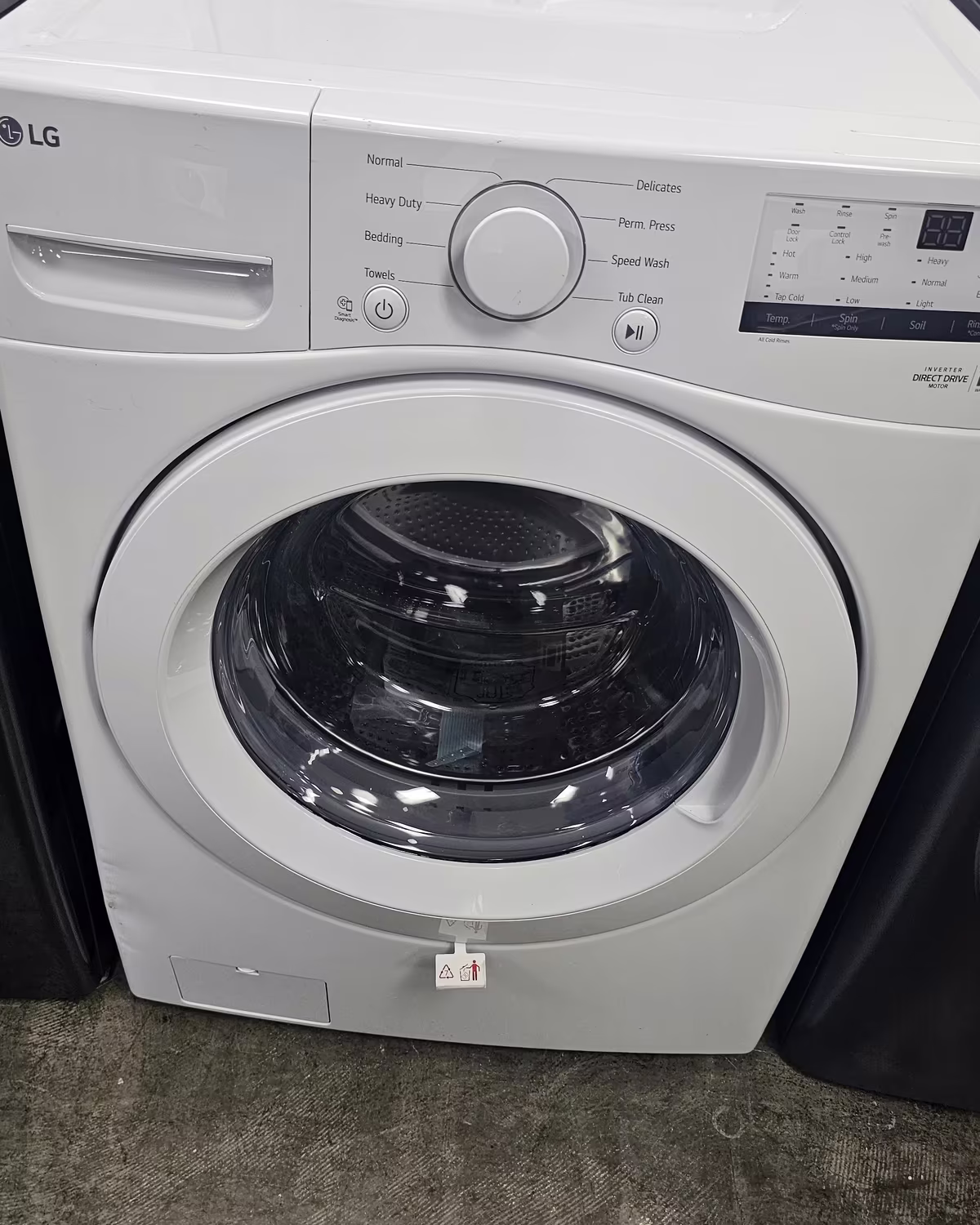 A white LG front-load washer on the showroom floor