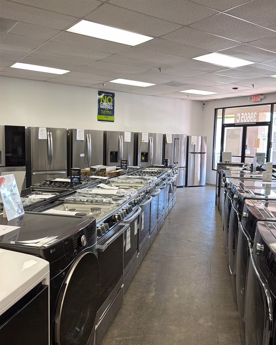 The long showroom aisle of washers, ranges and refrigerators